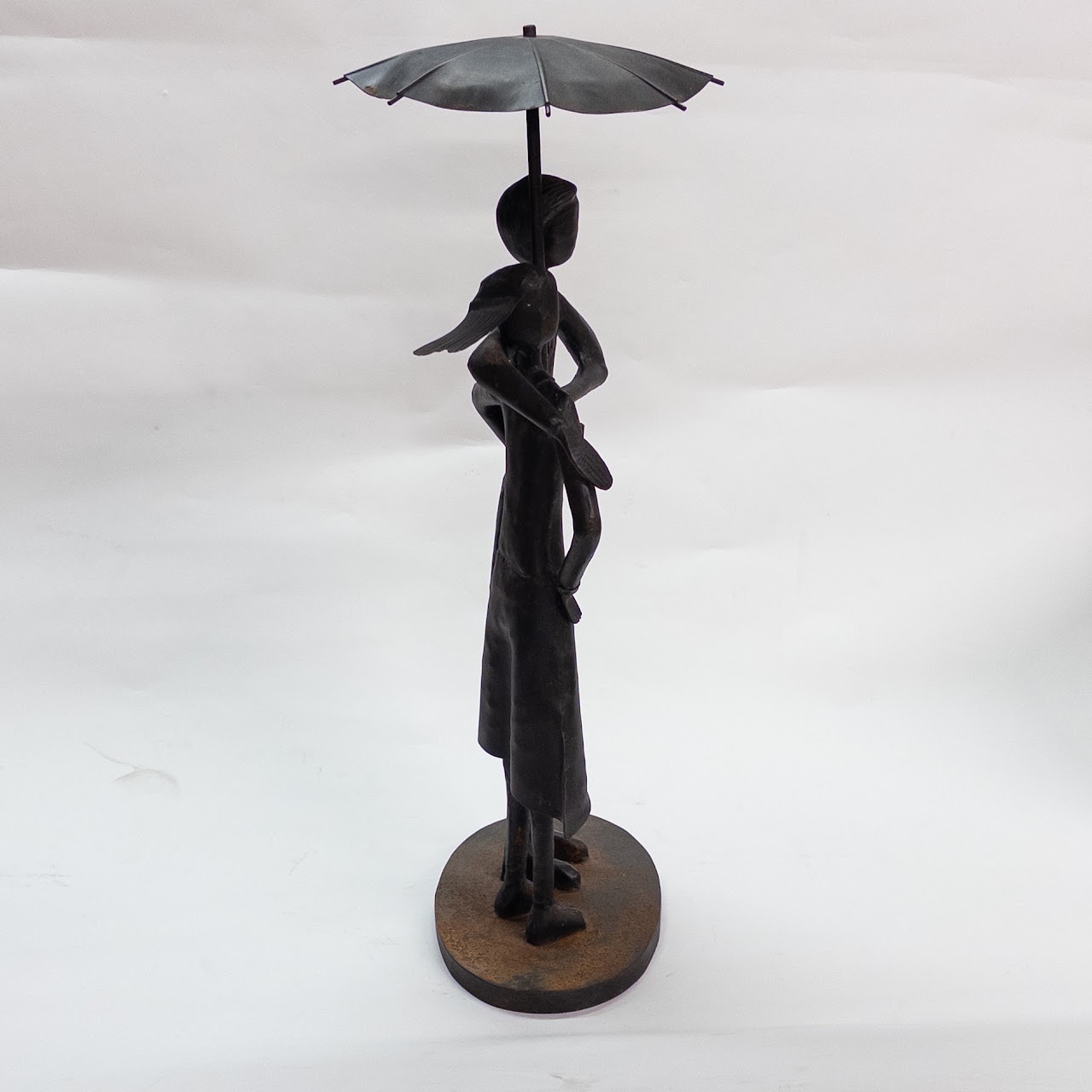 Distressed Metal Garden Statue of Two People in the Rain