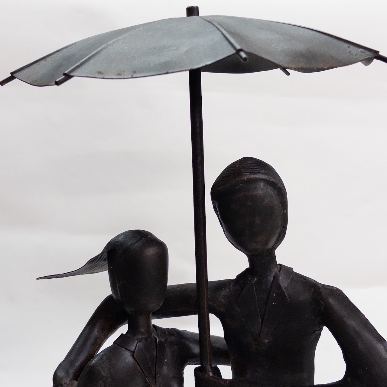Distressed Metal Garden Statue of Two People in the Rain