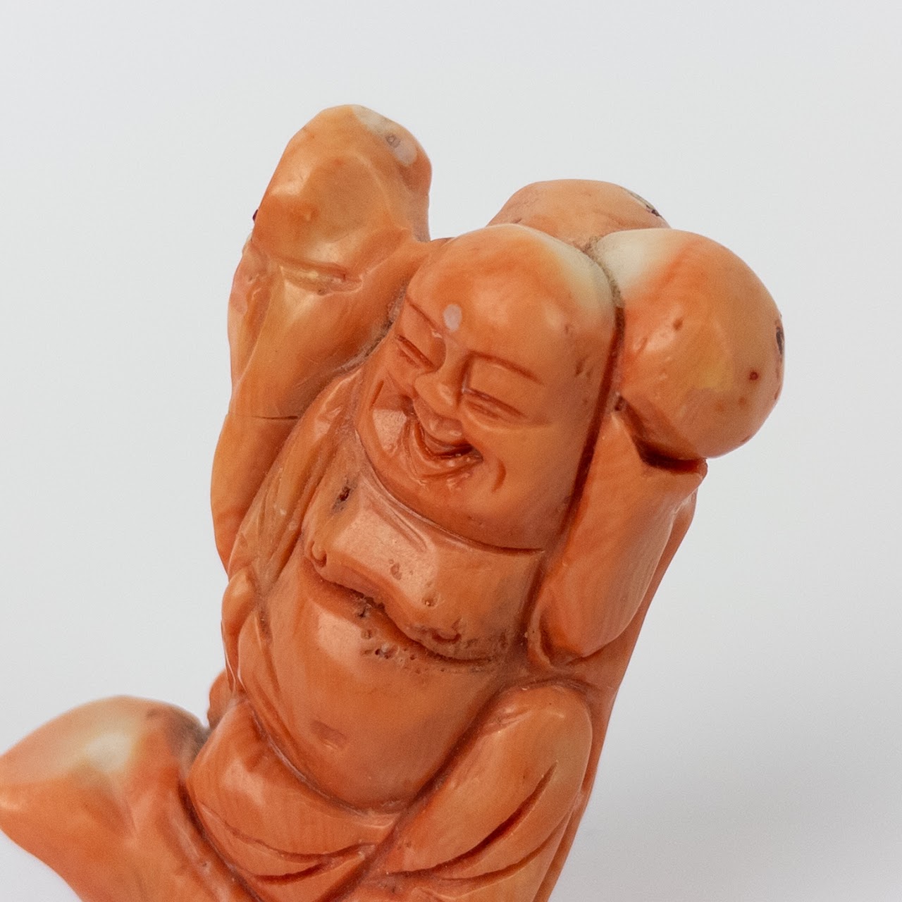 Coral Laughing Buddha Statuette