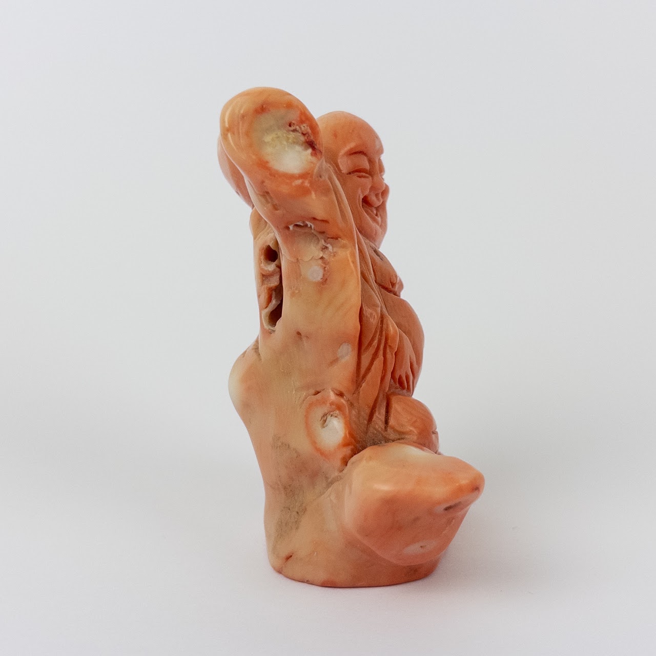 Coral Laughing Buddha Statuette