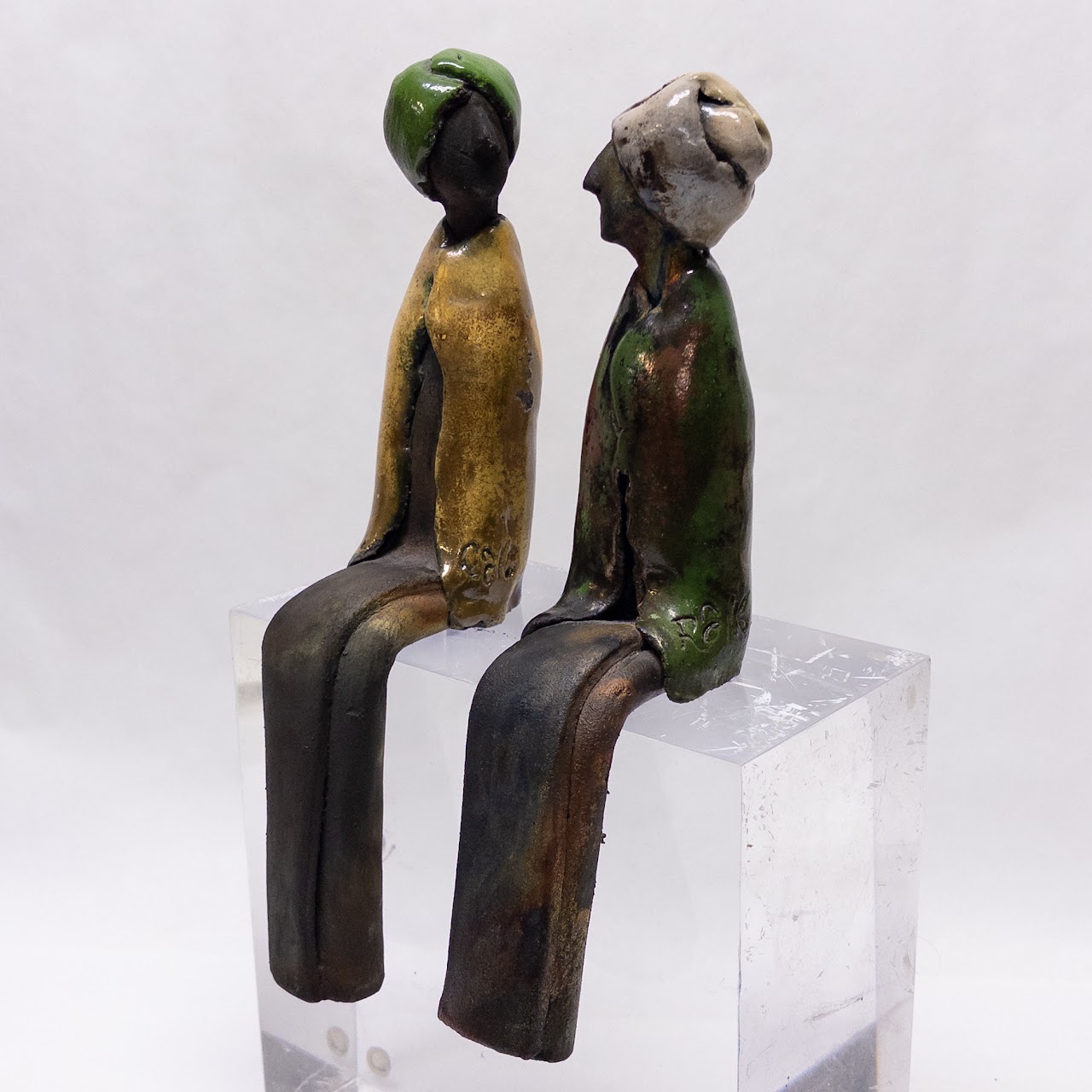 Signed Ceramic Pair of Table Edge Sitting Figurines