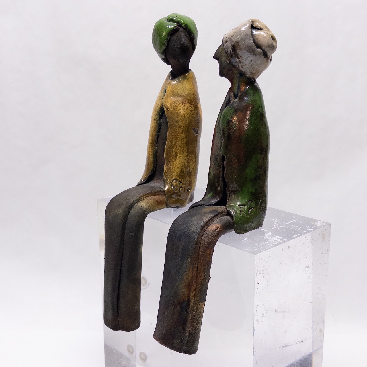 Signed Ceramic Pair of Table Edge Sitting Figurines