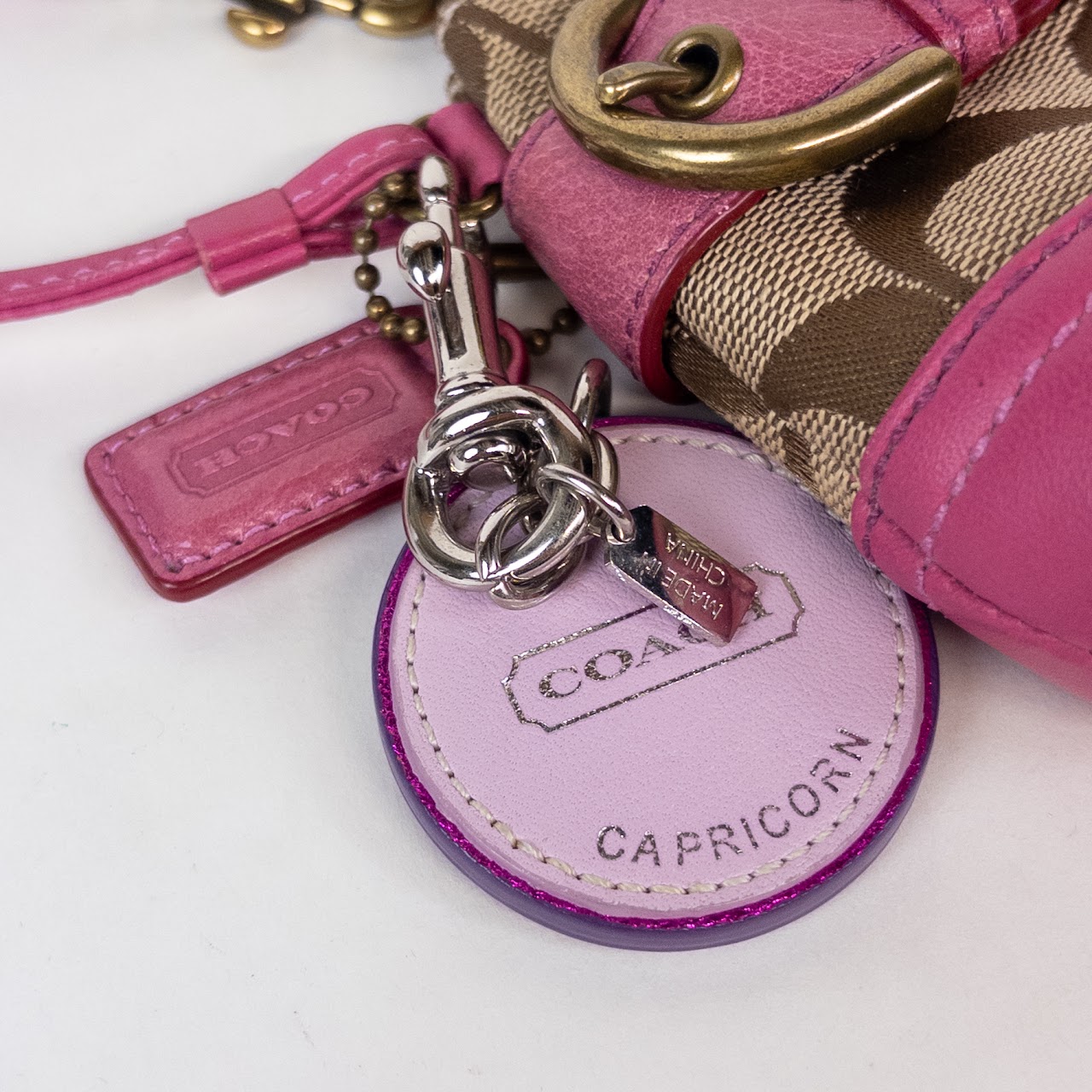 Coach Signature Monogram Wristlet with Capricorn Coach Charm